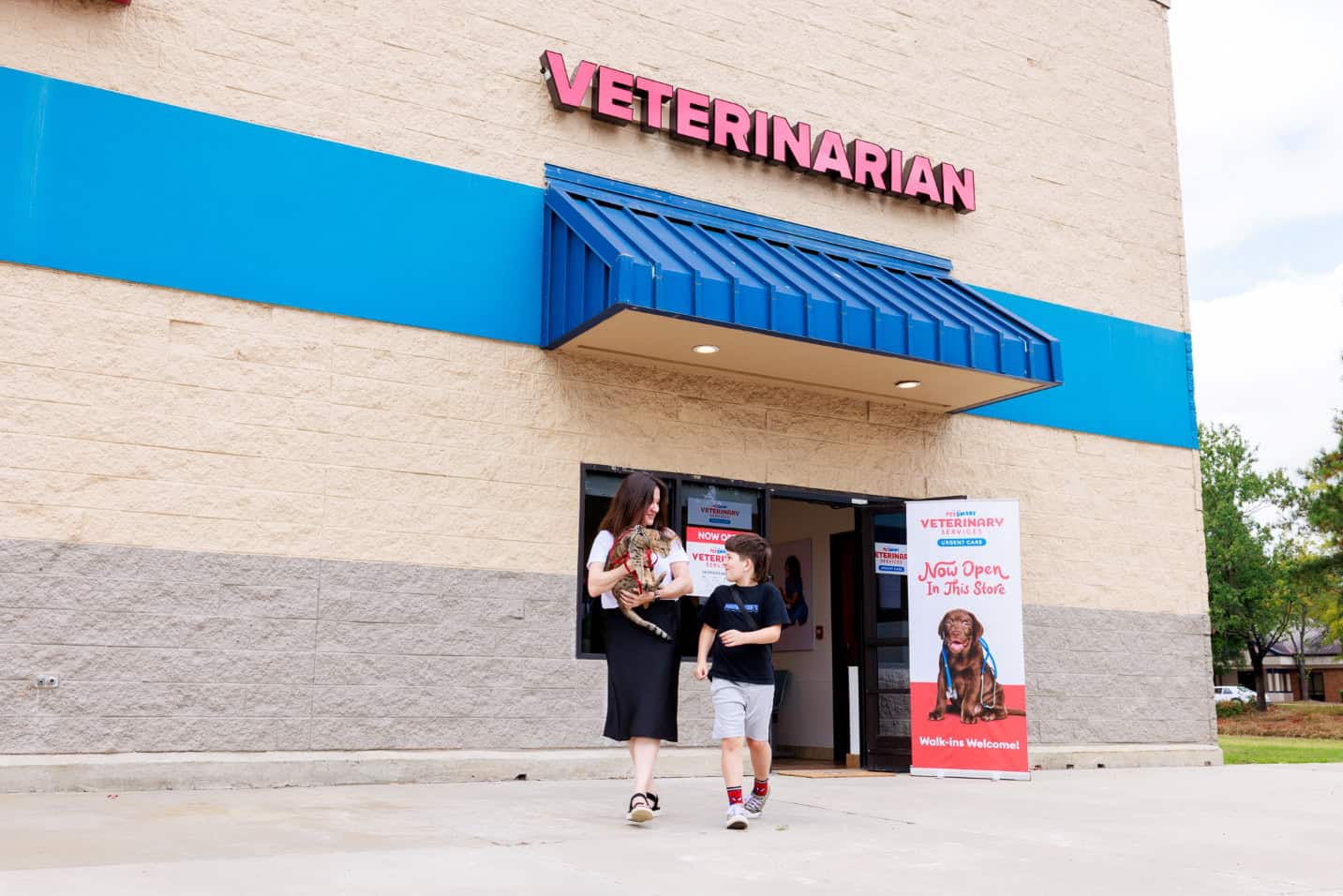 family in front of veterinary hospital with pet feline